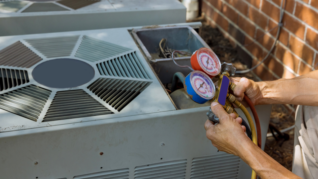 Technician uses refrigerant gauge manifold to service an outdoor air conditioner unit outside a home.